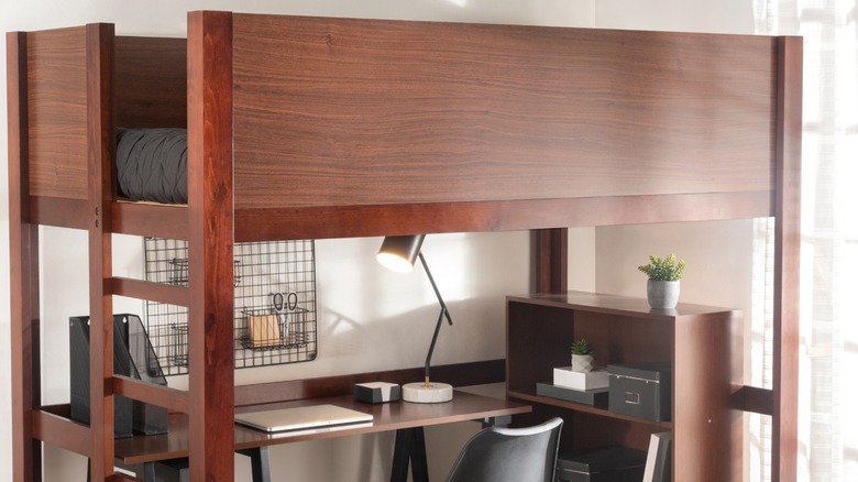 Twin-sized wood loft bed over desk and small bookcase