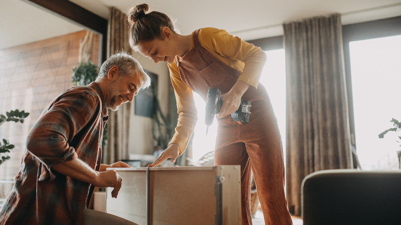 Two people work together to build a storage system