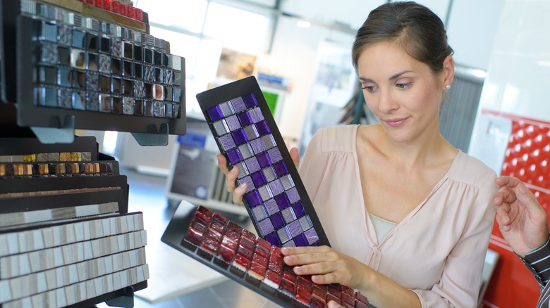 Woman picking colorful mosaic tiles