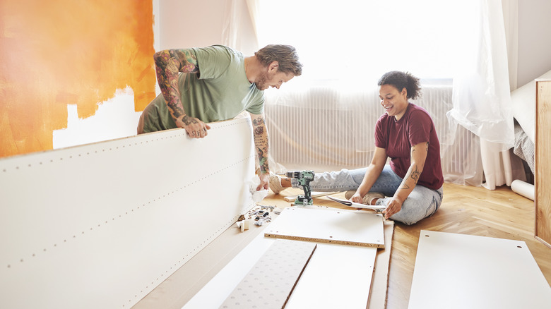 Couple building IKEA furniture