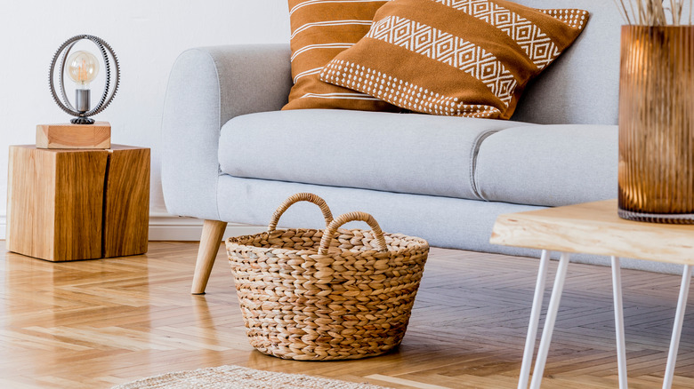 basket by sofa in living room