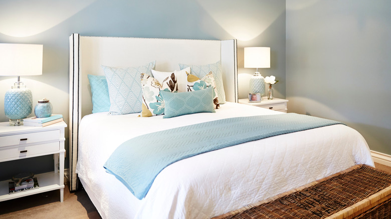 airy bedroom with blue bedding