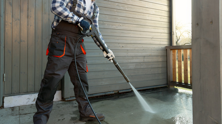 person power washing patio