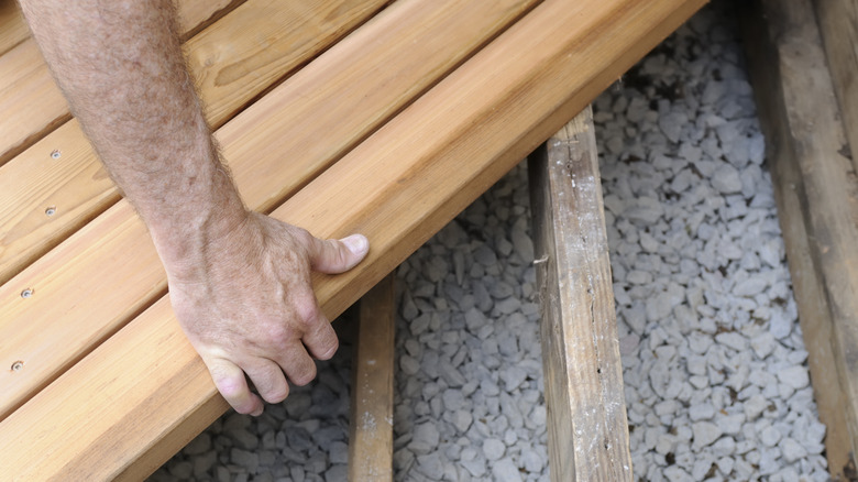 person repairing wood patio