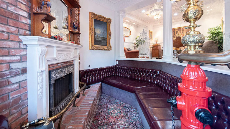 brick fireplace with leather couch