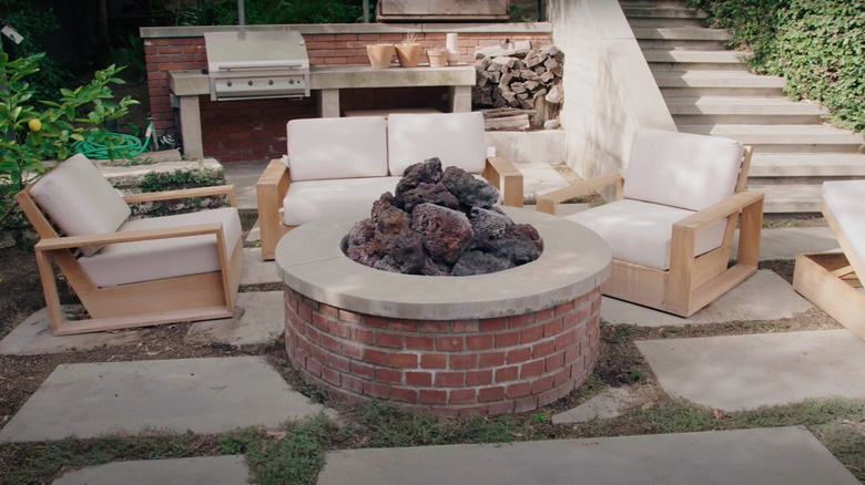 round outdoor fire pit with cushioned chairs