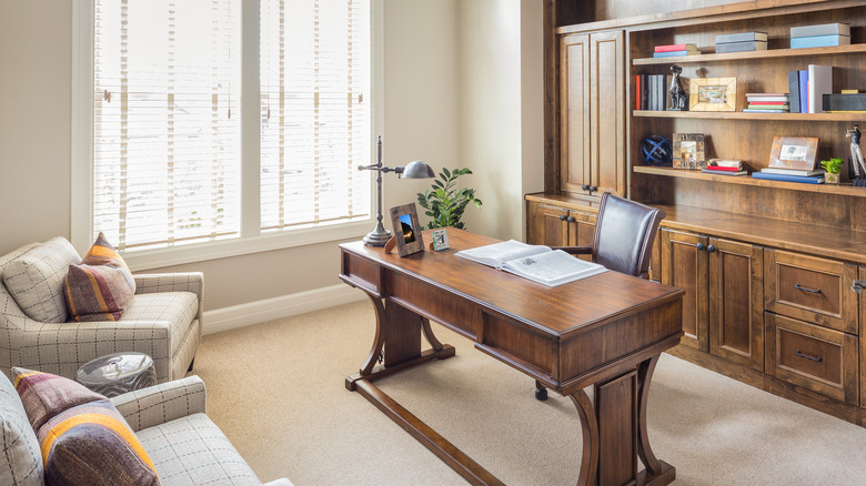 Elegant study with a bookshelf and an executive desk.