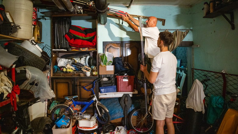 two men in messy garage