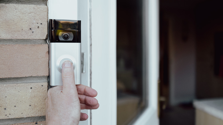 Person ringing Ring doorbell