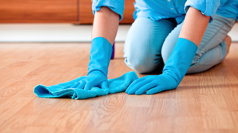 Person wiping floor with microfiber cloth