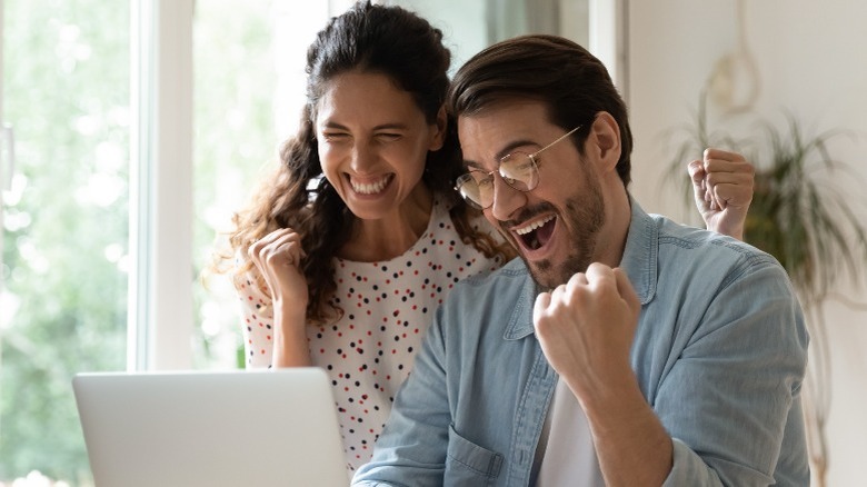 happy couple at computer