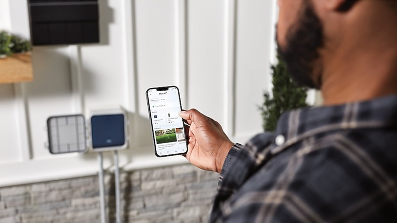 man setting lawn irrigation through app