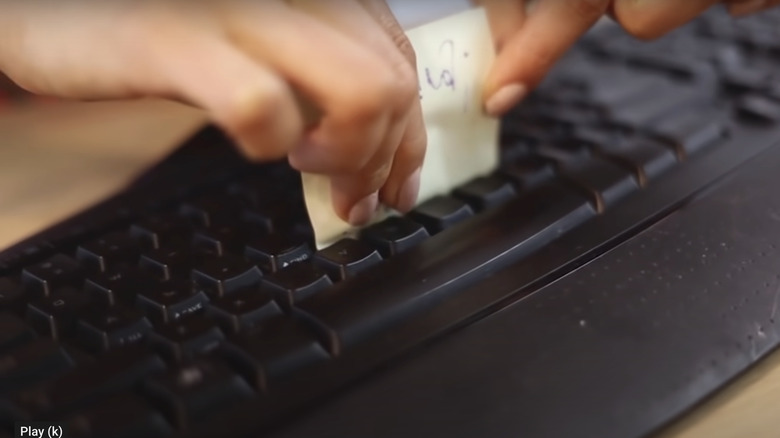 Cleaning keyboard with sticky note