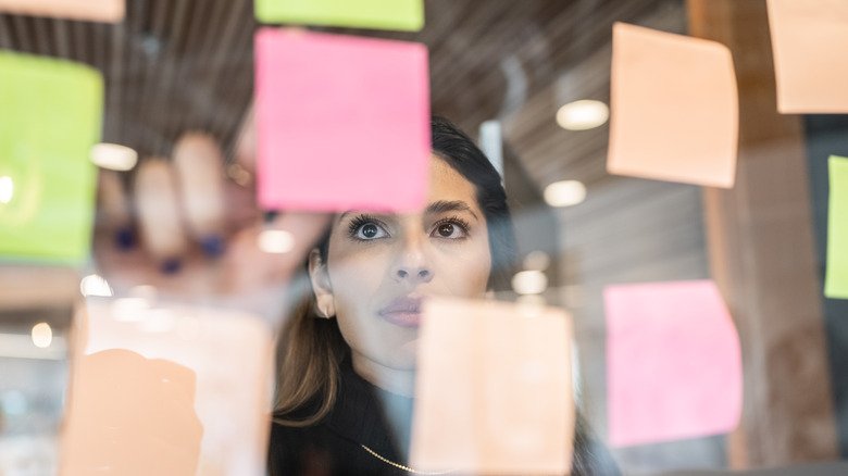 Woman using sticky note