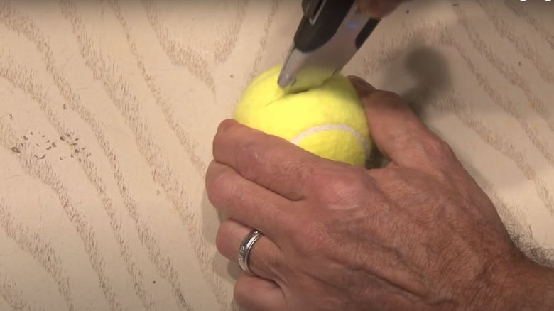 Someone cutting tennis ball