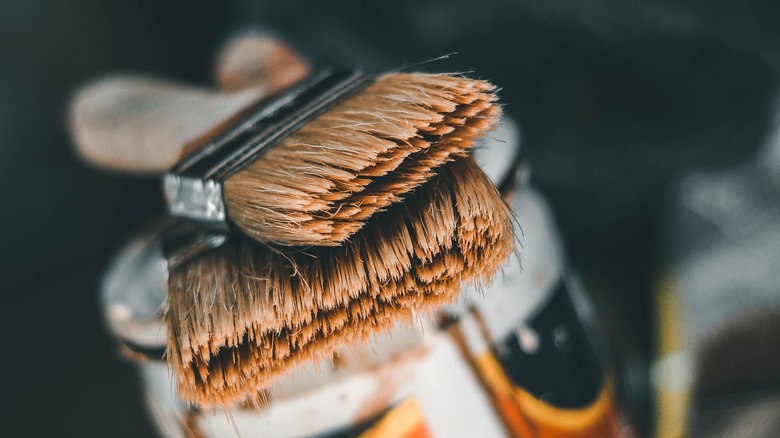 clean paintbrushes on can