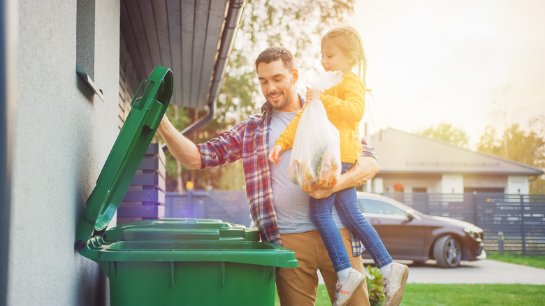 dad and daughter discard trash