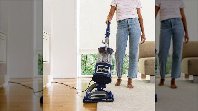person using blue vacuum