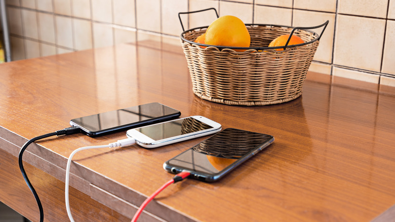 mobile phones charging on counter