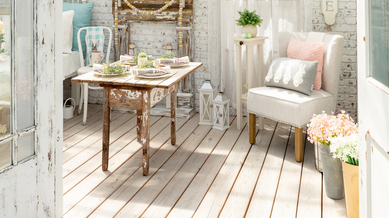 shabby chic room with fireplace, chair, and table