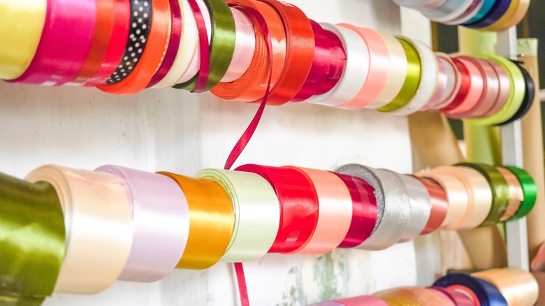 Spools of colorful ribbons hanging in home