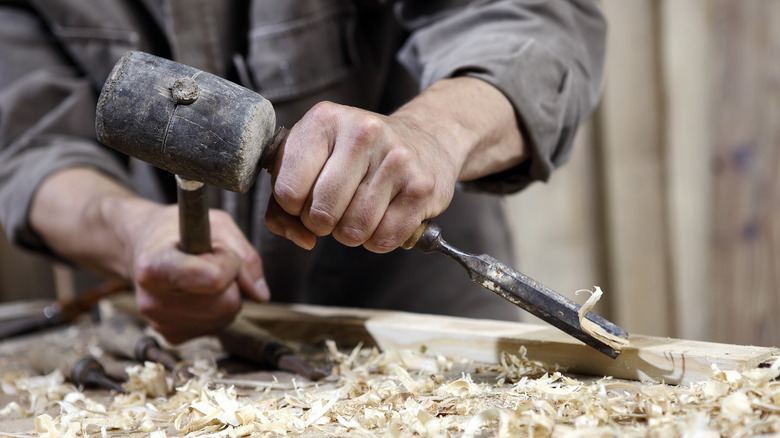 chisel and mallet cutting wood