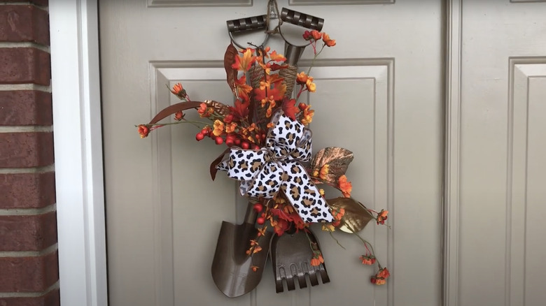 DIY Dollar Tree rake and shovel decoration with leaves and bow