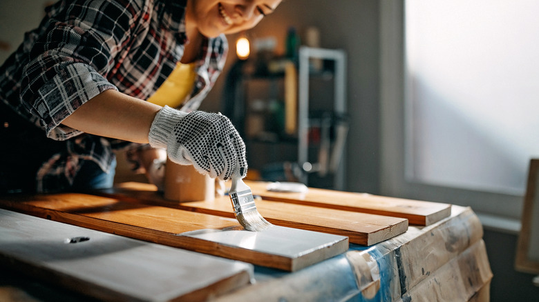 woman painting boards