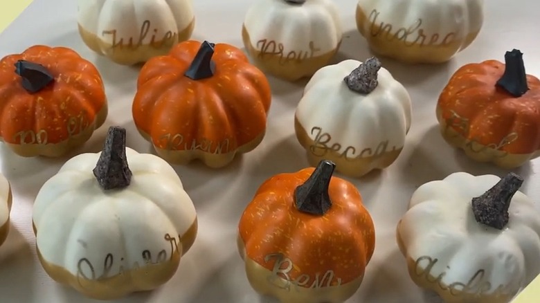 Gold painted white and orange mini pumpkins as table place card holders