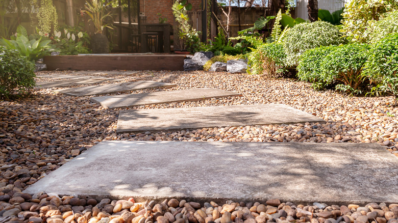 An outdoor path of walking stones is set within a bed of gravel.