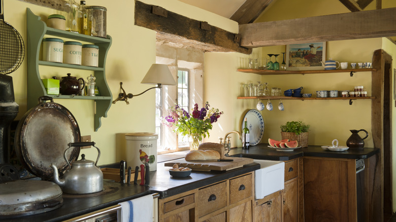 A country kitchen with the countertops and stovetop clearly visible.