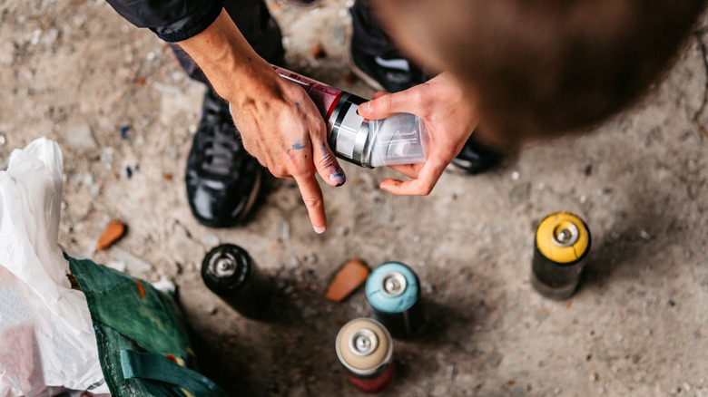 person with spray paint colors