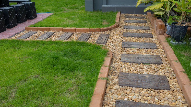 brick and paver pathway filled with decorative stone