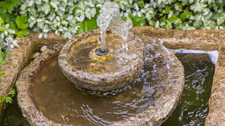 Stone water fountain in garden