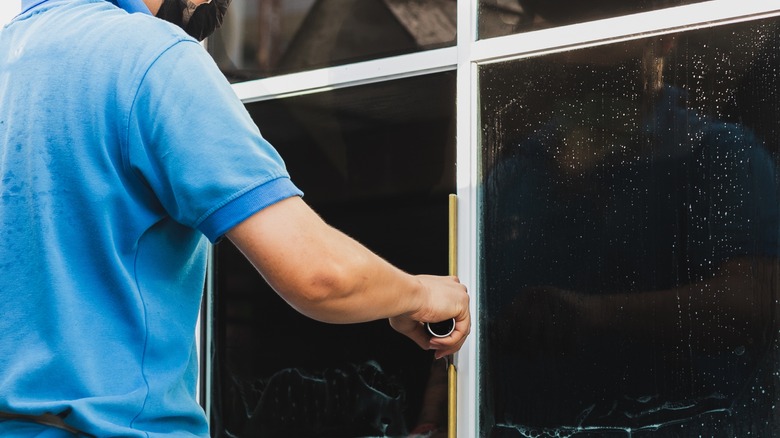 Man installing window film