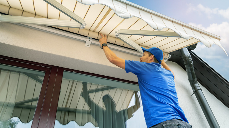 Person installing awning