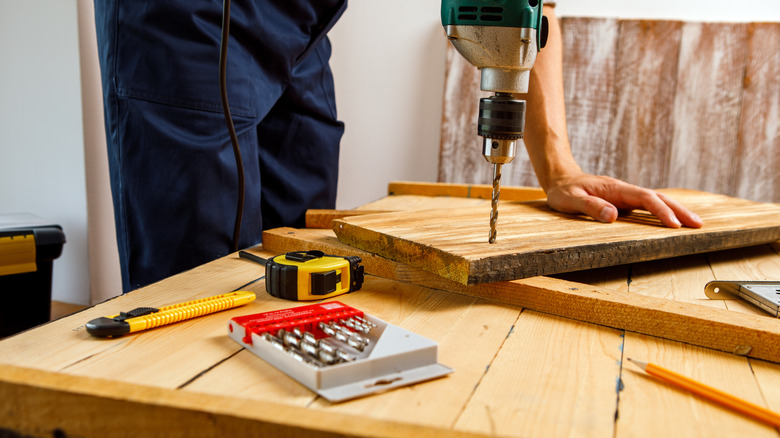 man drilling hole