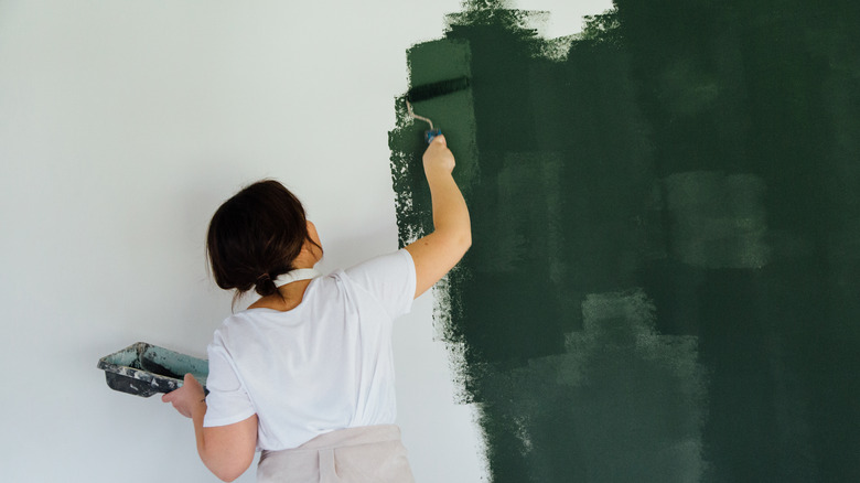 Woman painting wall