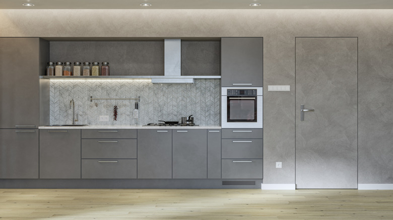 Grey kitchen with spice jars and an oven