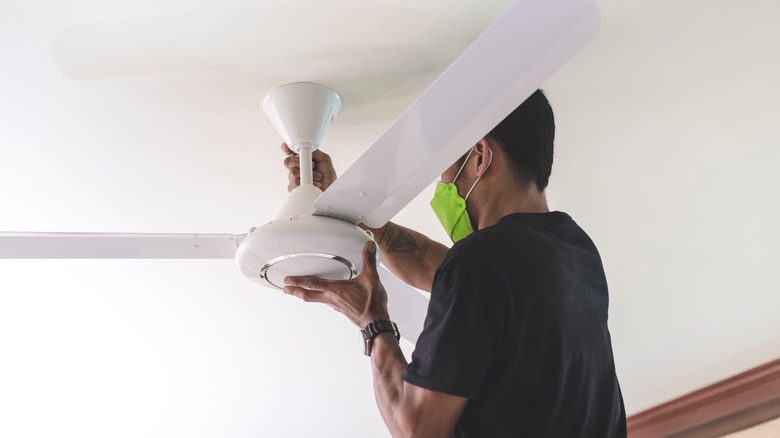 Man installing ceiling fan