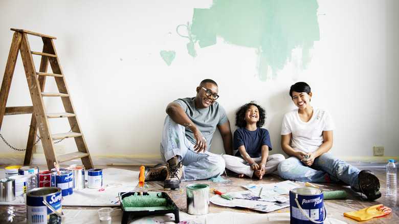 Family sitting, painting a room