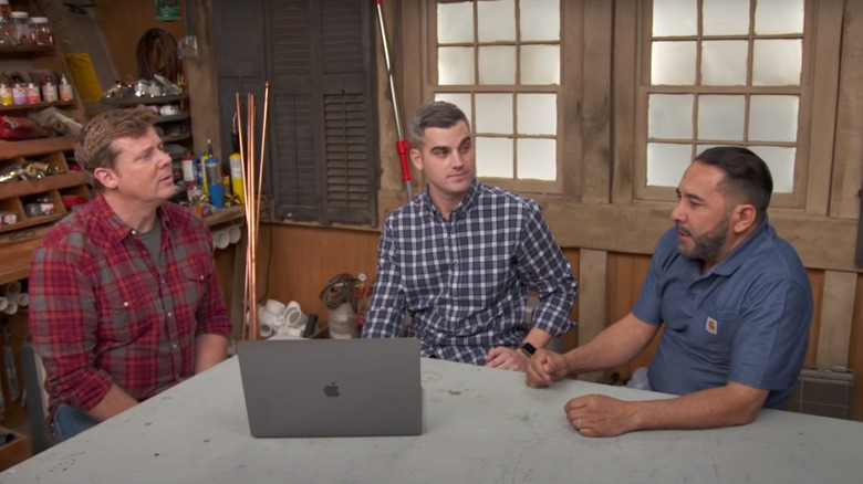 Three men and laptop