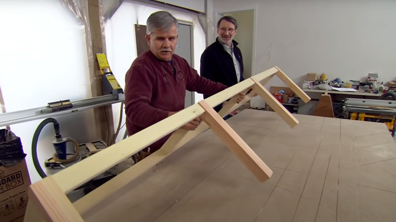 Two men building shelving