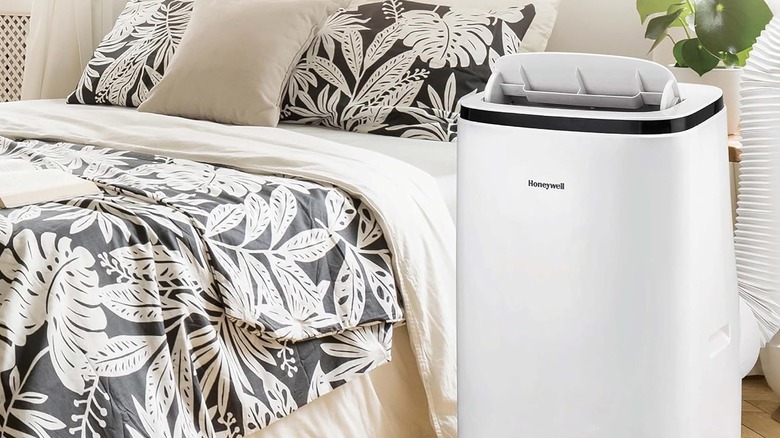 Honeywell portable air conditioner in front of a bed