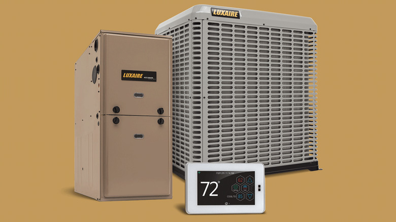 Components of a Luxaire central AC system on a brown background