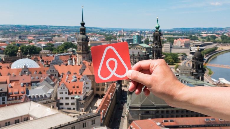 person holding airbnb tag