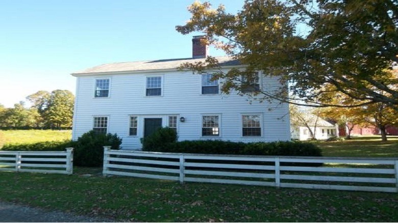 two-storey white house with picket fence