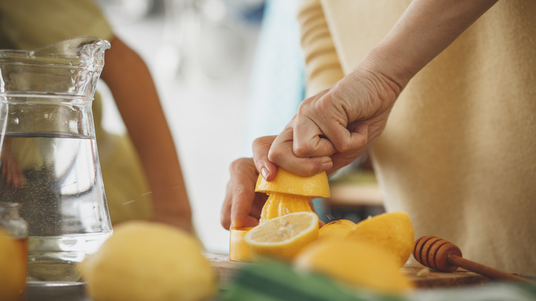 person squeezing lemon