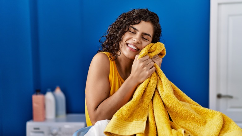 smiling woman hugging towel