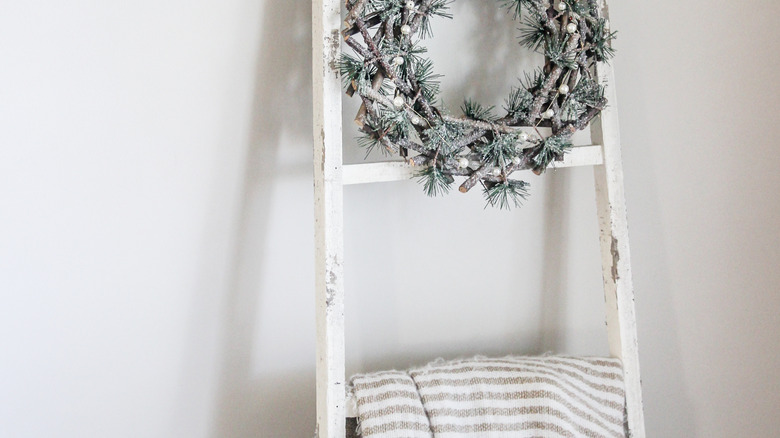 wreath hanging on blanket ladder